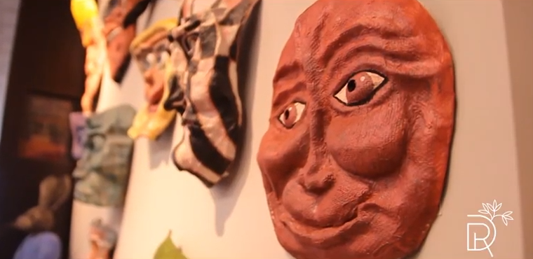 Image of masks on a wall being displayed