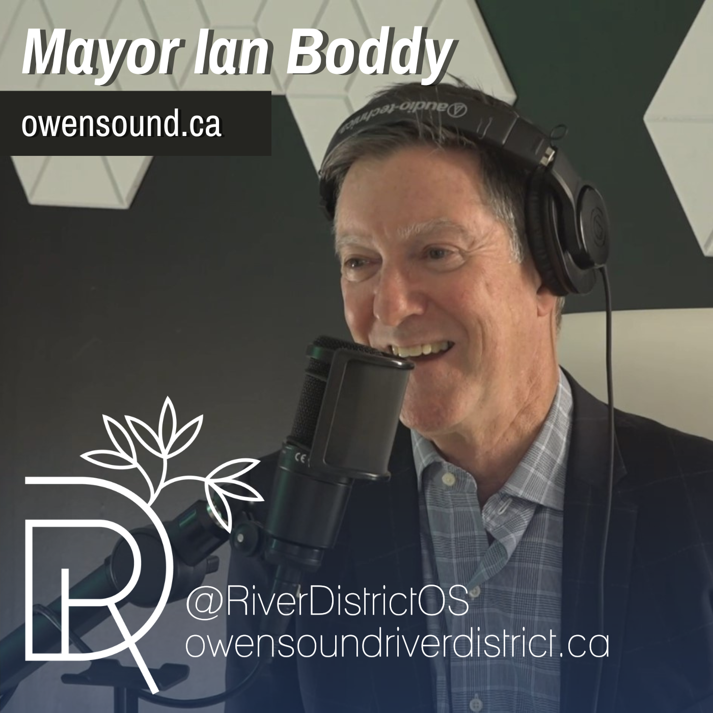 Mayor Ian Boddy in podcast studio behind microphone and wearing headphones