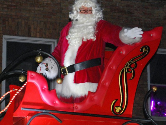 Kris Kringle waves to children along the route of the 76th annual Kiwanis Owen Sound Santa Claus parade Saturday evening. DENIS LANGLOIS