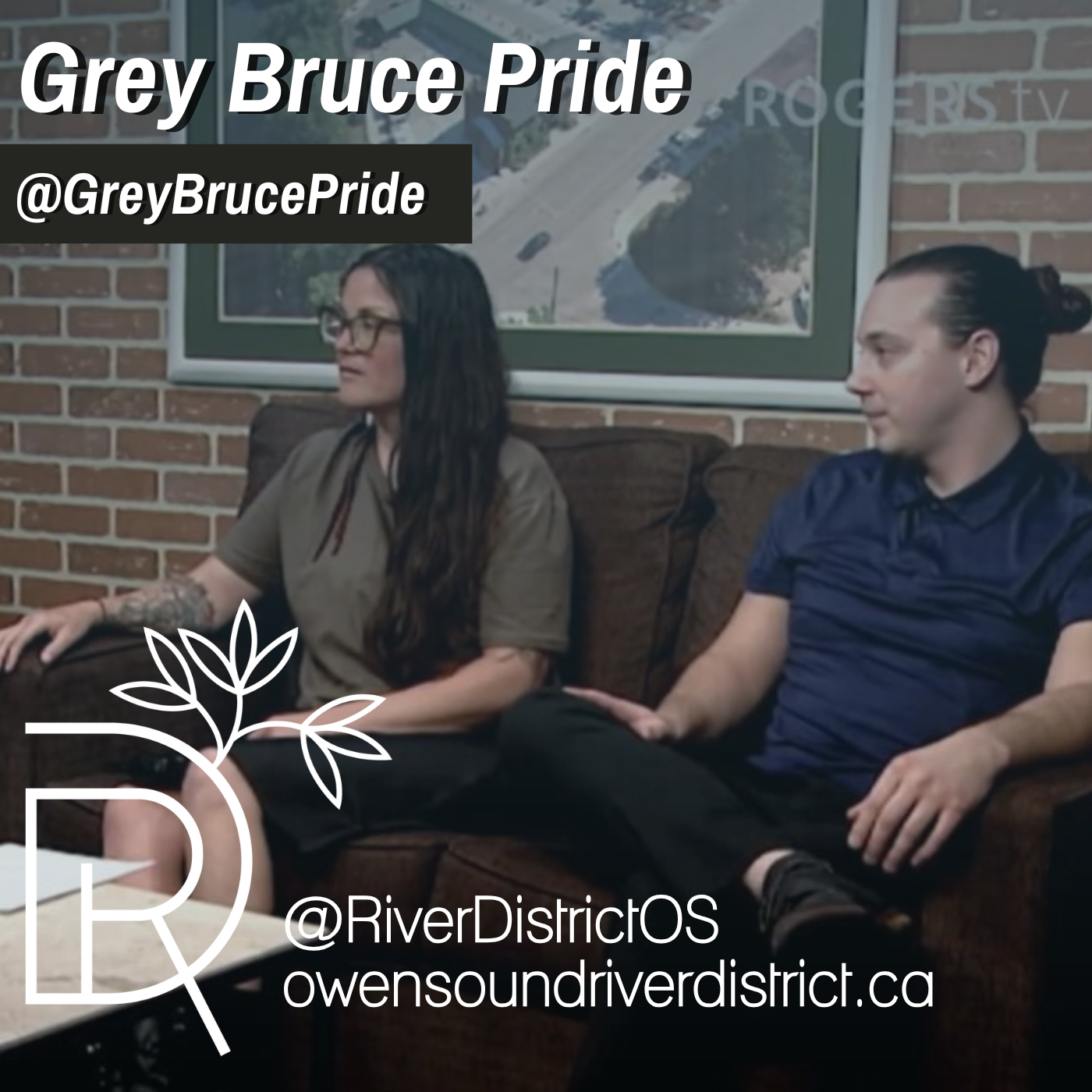 two people sitting in a dark couch against a faux brick wall