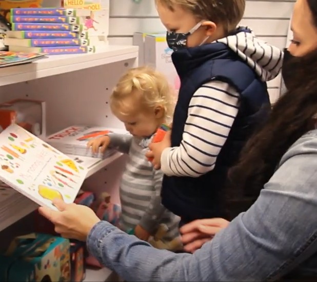 mother with two children shopping with books